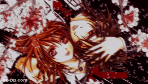 A Girl With Red Hair Is Surrounded By Flowers And Petals GIF