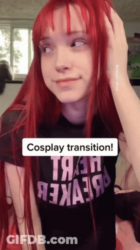 A Girl With Red Hair Is Wearing A Black Shirt That Says " Cosplay Transition " GIF