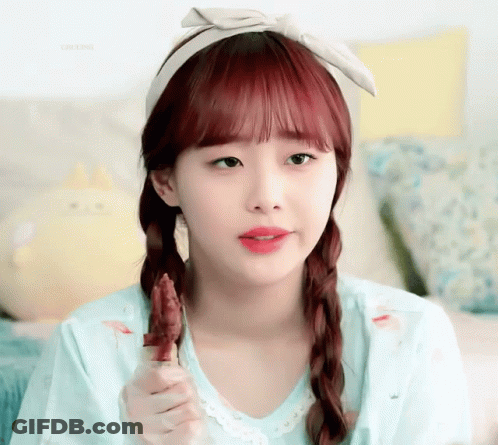 A Girl With Red Hair Is Wearing A Headband And Eating A Piece Of Meat GIF
