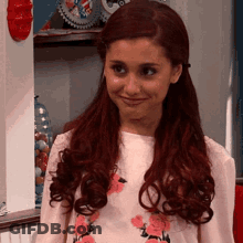 A Girl With Red Hair Is Wearing A Pink Shirt With Flowers On It GIF