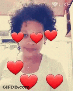 A Girl With Red Hearts Around Her Eyes And The Word Like In The Corner GIF