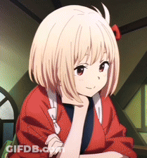 A Girl With Short Blonde Hair Is Wearing A Red Jacket And Has Her Hand On Her Chin GIF