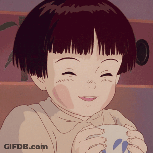 A Girl With Short Hair Is Smiling While Holding A Cup GIF