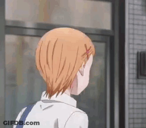 A Girl With Short Orange Hair Is Walking In Front Of A Building . GIF
