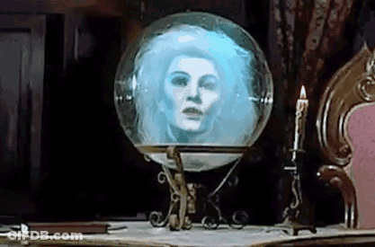 A Glass Ball With A Woman 'S Face In It Is On A Table . GIF