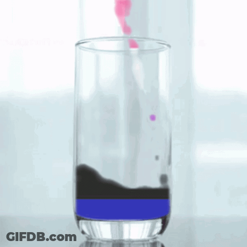 A Glass Filled With A Purple And Black Liquid GIF