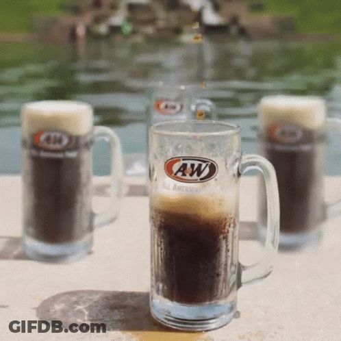 A Glass Of A&w Beer Sits On A Patio GIF