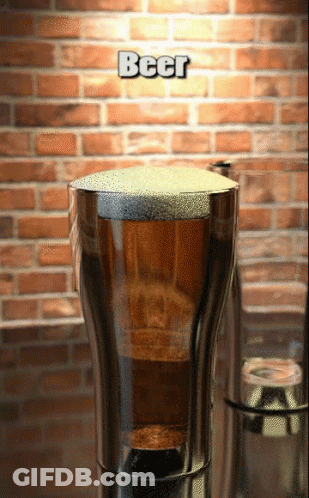 A Glass Of Beer With A Brick Wall In The Background GIF