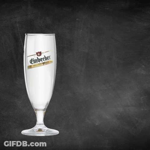A Glass Of Einbecher Sits On A Blackboard GIF