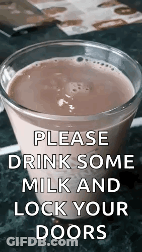 A Glass Of Milk Is On A Table With A Sign That Says Please Drink Some Milk And Lock Your Doors . GIF