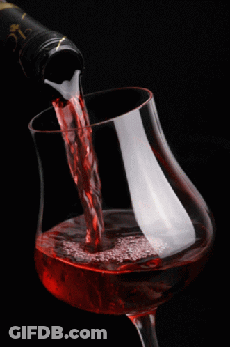 A Glass Of Wine Is Being Poured From A Bottle That Says Clc On It GIF