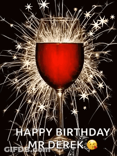 A Glass Of Wine Is Surrounded By Sparklers On A Black Background . GIF
