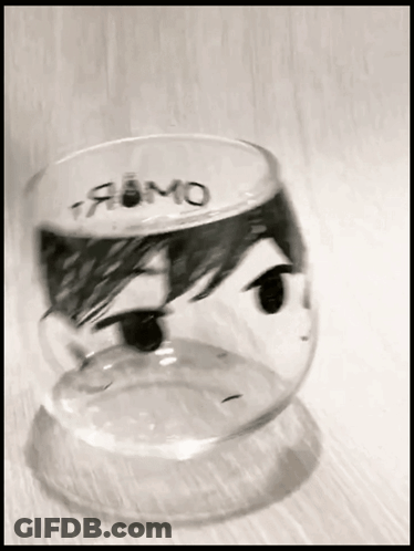 A Glass With A Drawing Of A Person 'S Face And The Word Fumo Written On It GIF