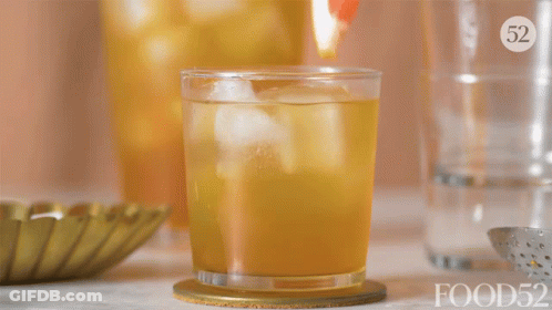 A Glass With A Slice Of Grapefruit In It And The Number 52 On The Top GIF