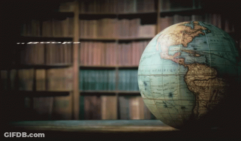 A Globe Sits On A Table Next To A Quote From Stephen King GIF