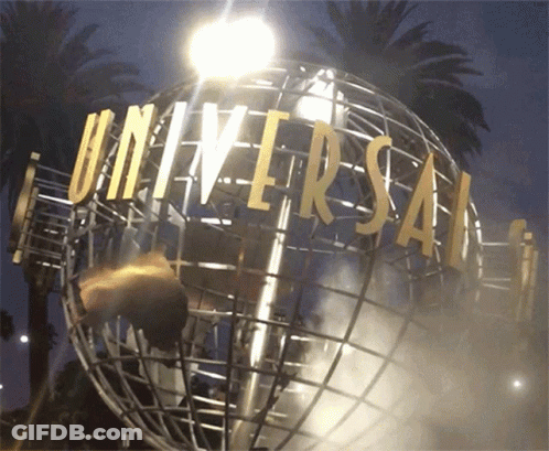 A Globe With Universal Written On It Is Lit Up At Night GIF