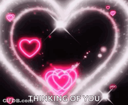 A Glowing Heart With The Words `` Thinking Of You '' In The Middle . GIF