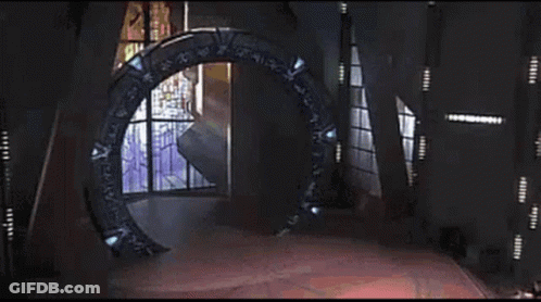 A Glowing Light Is Coming Out Of A Portal In The Middle Of A Room . GIF