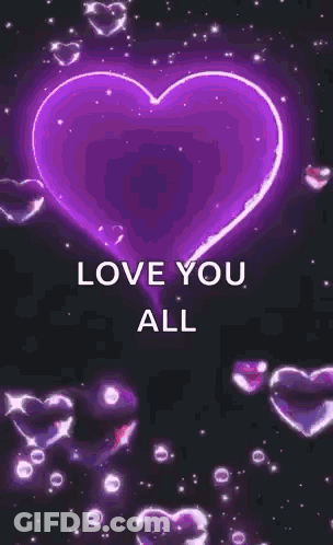A Glowing Pink Heart With The Words `` Love You All '' Surrounded By Hearts On A Black Background . GIF