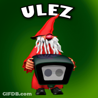 A Gnome With A Red Hat And A Beard Is Holding A Box With The Word Ulez On It GIF