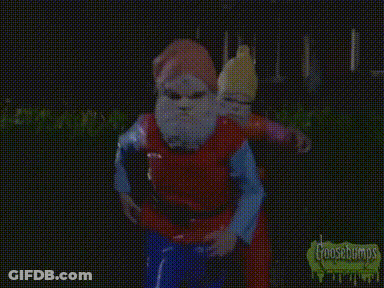 A Gnome With A Red Hat And White Beard Is Wearing A Yellow Shirt . GIF