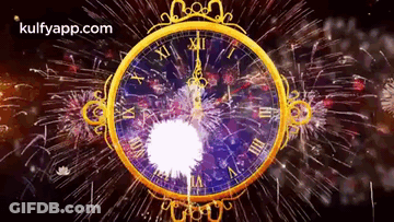 A Gold Clock With Roman Numerals And Fireworks Behind It GIF