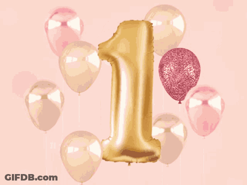 A Gold Number 1 Balloon Is Surrounded By Pink And Gold Balloons GIF