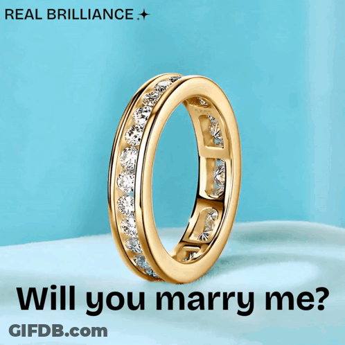 A Gold Ring With The Words " Will You Marry Me " On It GIF