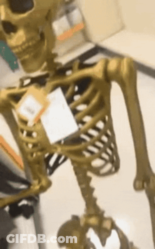 A Gold Skeleton With A Tag On It That Says ' Skeleton ' On It GIF