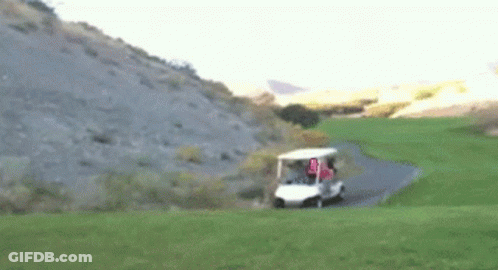 A Golf Cart Is Driving Down A Path On A Golf Course With A Flag That Says U.s.a. GIF