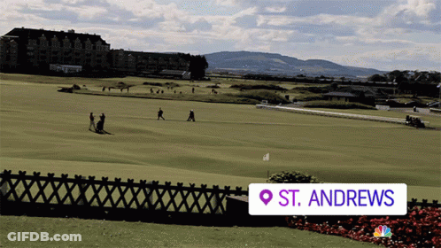 A Golf Course In St. Andrews Is Shown With A Fence In The Foreground GIF