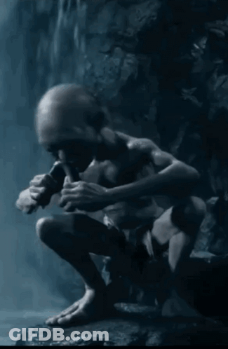 A Gollum Sitting On A Rock Playing A Flute In The Dark GIF