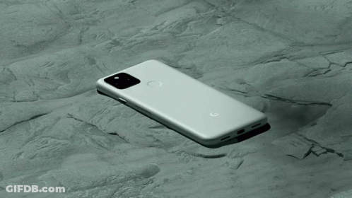 A Google Phone Is Laying On Its Back On A Rocky Surface GIF