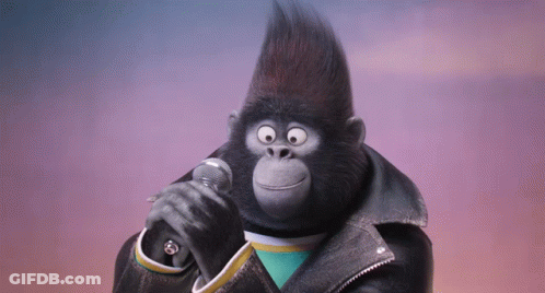 A Gorilla Singing Into A Microphone Wearing A Black Leather Jacket GIF