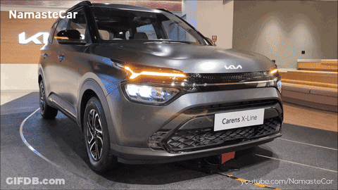 A Gray Car With The Word Carens On The Front GIF
