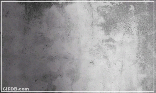 A Gray Concrete Wall With A White Frame In The Middle GIF