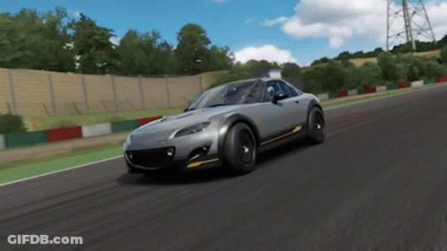 A Gray Sports Car Is Driving On A Track GIF