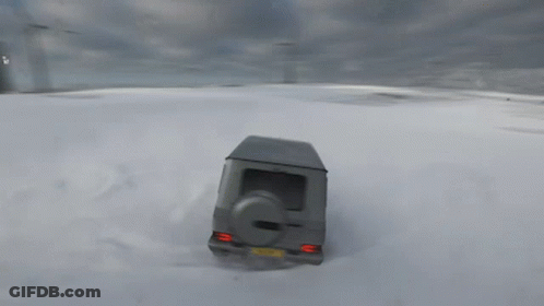 A Gray Suv Is Driving Through A Snowy Field GIF