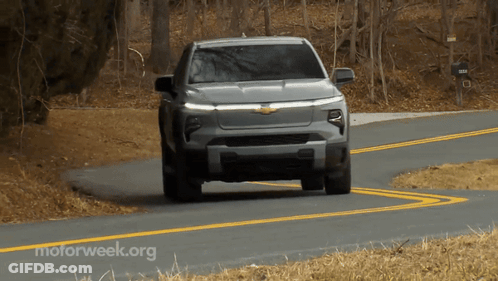 A Gray Truck Is Driving Down A Road With Motorweek.org Written On The Bottom GIF