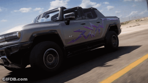 A Gray Truck With Purple Arrows Painted On The Side Is Driving Down A Road GIF