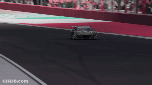 A Green Acura Race Car Is Driving On A Race Track GIF