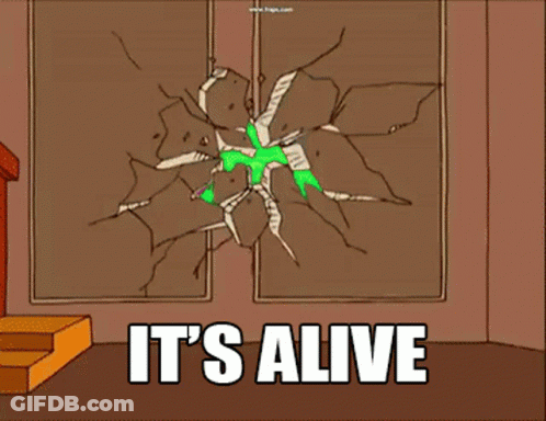 A Green Alien Is Breaking Through A Wall With The Words It 'S Alive GIF