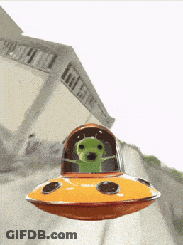 A Green Alien Is Flying In An Orange Ufo GIF