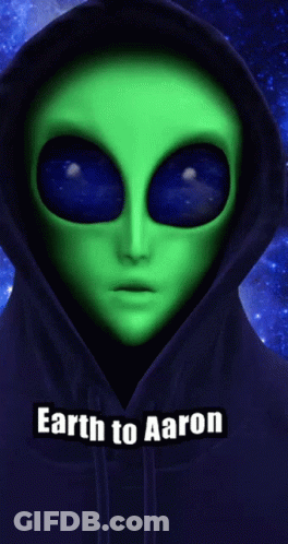 A Green Alien Wearing A Blue Hoodie With The Words " Earth To Aaron " Below It GIF