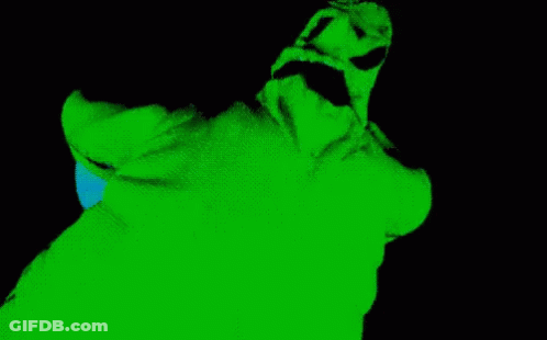 A Green And Black Image Of A Person 'S Face With A Blue Light Coming Out Of It GIF