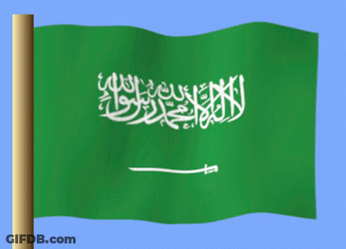 A Green And White Flag With Arabic Writing On It Is Flying In The Wind GIF
