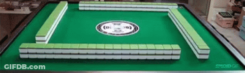 A Green And White Mahjong Board With A White Circle On It GIF
