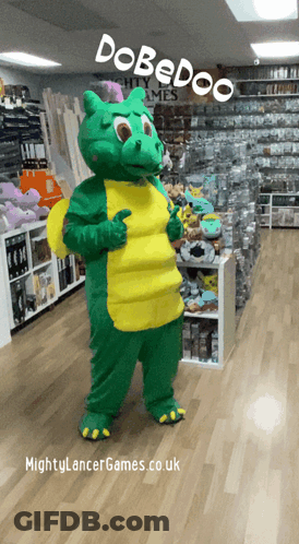 A Green And Yellow Dragon Mascot Is Standing In A Store With The Words Dobedoo On The Top GIF