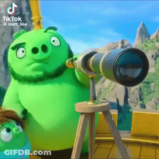 A Green Angry Birds Pig Is Looking Through A Telescope . GIF