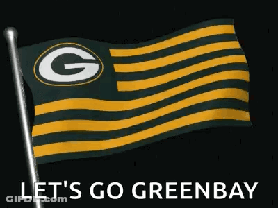 A Green Bay Packers Flag Is Flying In The Wind On A Pole . GIF